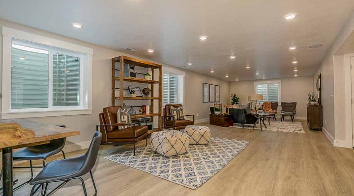 A large, modern living room area with stylish furniture and ample lighting, showcasing contemporary interior design and spacious home layout.